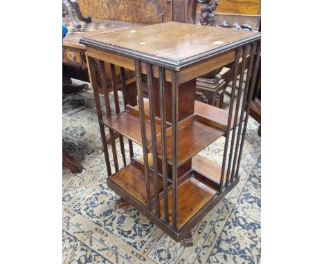 AN EARLY 20th C. MAHOGANY ROTARY BOOKCASE, A SATIN WOOD BAND TO THE TOP ENCLOSING A FOLIATE ROSETTE ROUNDEL