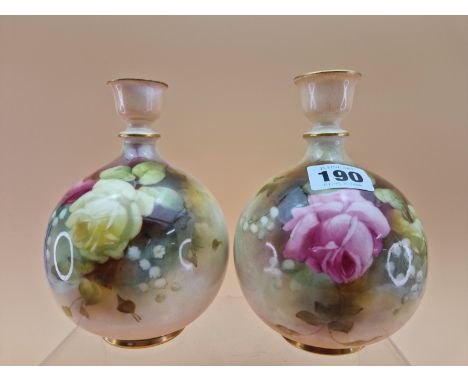 A PAIR OF 1911 ROYAL WORCESTER VASES, THE COMPRESSED SPHERICAL BODIES PAINTED WITH ROSES.   H 15.5cms. 