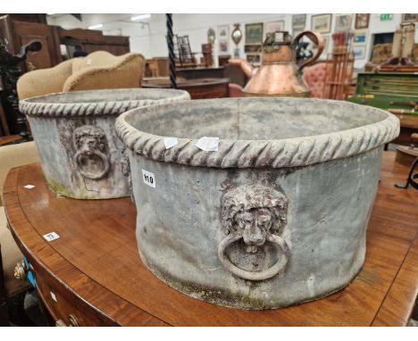 A PAIR OF 19th C. LEAD CYLINDRICAL PLANTERS WITH GADROONED RIMS ABOVE FOUR LION MASK AND RING HANDLES.   Dia. 49x G 26cms.