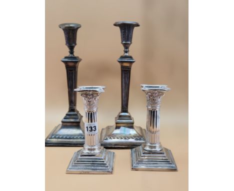 A PAIR OF SILVER STOP FLUTED CORINTHIAN COLUMN CANDLESTICKS BY HARRISON BROTHERS AND HOWSON, SHEFFIELD 1888, LOADED.   H 16cm