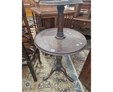 A GEORGE III MAHOGANY DUMB WAITER, THE TWO DISHED CIRCULAR TIERS ON GUN BARREL COLUMNS AND A TRIPOD WITH LONG NOSE CLUB FEET