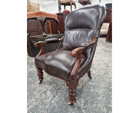 A VICTORIAN MAHOGANY ARMCHAIR UPHOLSTERED IN BROWN, THE BOBBIN TURNED FRONT LEGS ON CASTER FEET