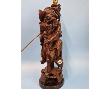 A CHINESE CARVED WOOD TABLE LAMP IN FORM OF THE DAOIST IMMORTAL LITIEGUAI.   H 56cms.