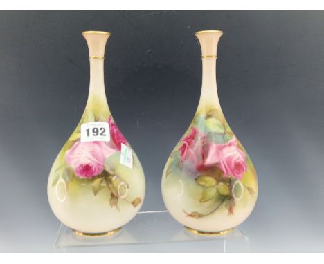 A PAIR OF EARLY 20th C. ROYAL WORCESTER BOTTLE VASES PAINTED WITH RED ROSES.   H 21.5cms.