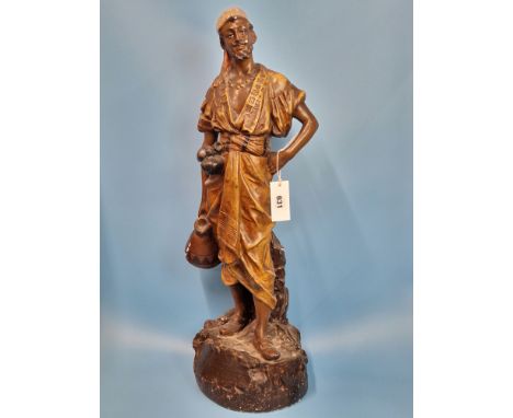 A PAINTED PLASTER FIGURE OF A NORTH AFRICAN MAN STANDING HOLDING A WATER PITCHER.   H 67cms.