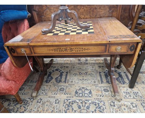 A MAHOGANY FLAP TOP GAMES TABLE DECORATED WITH AN EBONISED SCROLL BAND, THE CENTRE OF THE TOP REVERSIBLE WITH A CHESS BOARD O