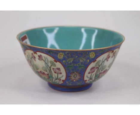 A Chinese porcelain bowl, enamel decorated with lillies, dia.16cm