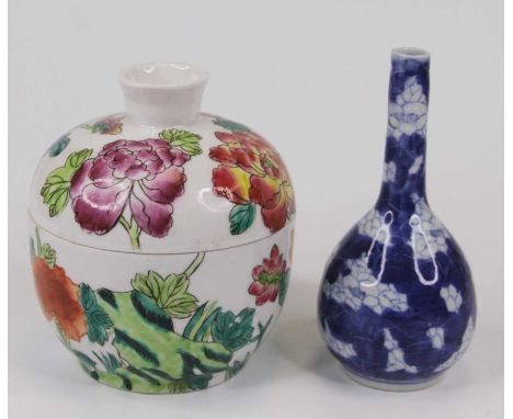 A Chinese porcelain bottle vase in the blue and white prunus pattern; together with a Chinese jar and cover, enamel decorated