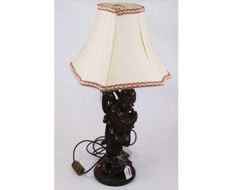 A Chinese carved hardwood figural table lamp and shade, height including shade 61cm