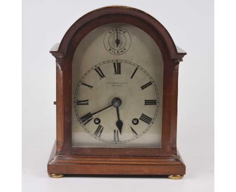 An Edwardian walnut case mantel clock, the painted dial with Roman numeral markers, and strikes silent, signed R McDowell & C