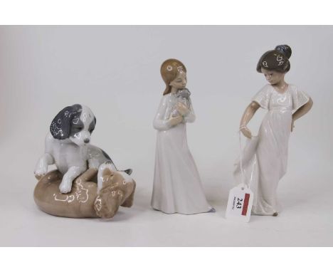 A Nao porcelain figure of a girl in a white dress, h.21cm; together with two other Nao porcelain figures