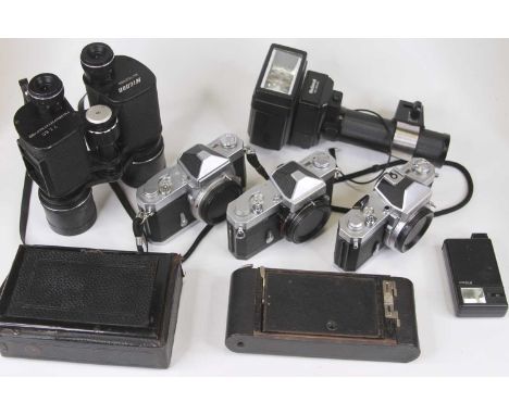 A box of vintage cameras and related equipment to include a Nikkormat and a pair of binoculars