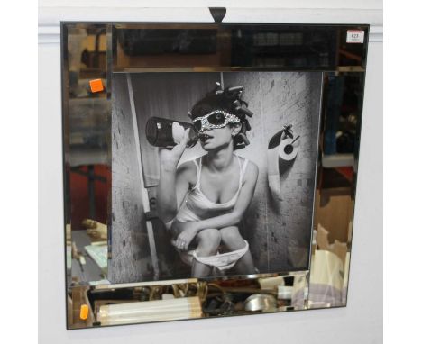 A portrait photograph of a lady, heightened with glitter, housed within a mirrored frame, overall 56x56cm