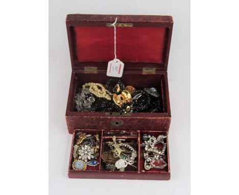 A red leather clad jewellery box and contents to include paste set flower head brooch, enamel brooch in the form of a lizard,