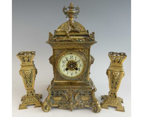 A late 19th century French cast and gilt brass three-piece clock garniture, comprising; clock of domed architectural form sur