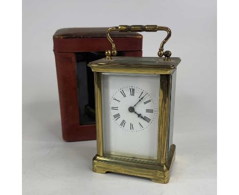 An early 20th century lacquered brass cased carriage clock, having an enamel dial with Roman numerals, visible platform lever