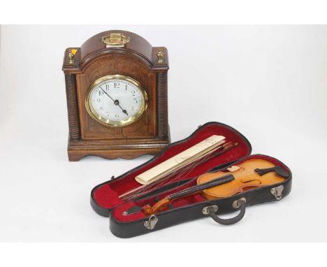 An Edwardian walnut and inlaid mantel clock, the enamelled dial showing Arabic numerals, the case having ring turned pilaster