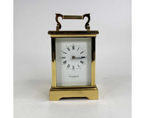 A 20th century lacquered brass cased carriage clock, the white enamel dial with inner Roman numerals and Arabic outer scale, 