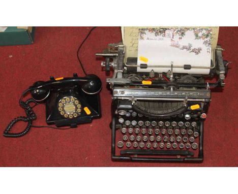 An early 20th century Underwood typewriter, together with a vintage style black telephone 