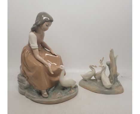 Two Nao figures, one of a girl feeding a goose and one of a group of geese (2). 