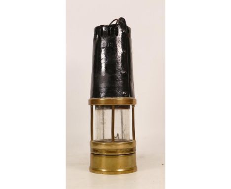 A Brass Miners Lamp with Painted Black upper Section, and padlocked lower section. Top is worn but reads Richard Johnson, Cla