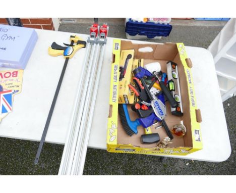 A collection of DIY hand tools including clamps, tile cutters, hammers etc 