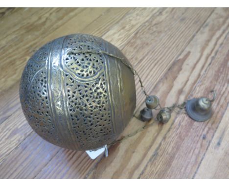 A Moroccan style pierced brass pendant light shade, of globular form, 21 cm diameter 