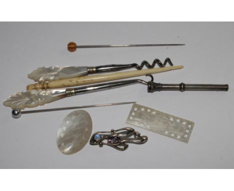 A mother of pearl button hook, mother of pearl gaming counters, hat pins and other collectables