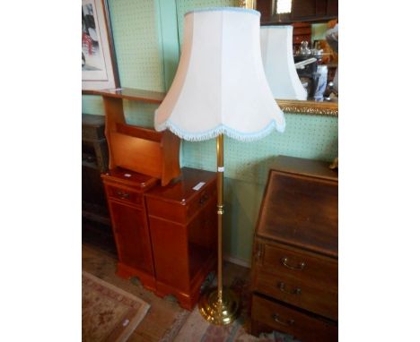 A modern brass standard lamp with shade.