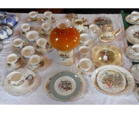 A quantity of hunting scene tableware, together with similarly themed table lamp, musical jug and other items.