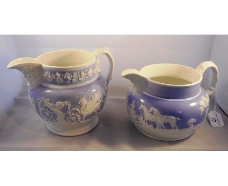 Two lilac ground jugs, one decorated with an applied hunting scene and the other with cherubs and mystical beasts.  Tallest 1