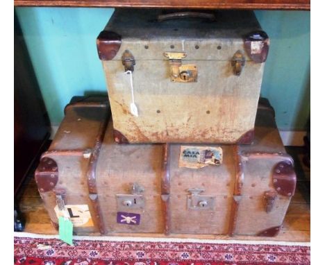 An early 20th century canvas and leather cabin trunk, together with a larger trunk with assorted travel labels, similar perio