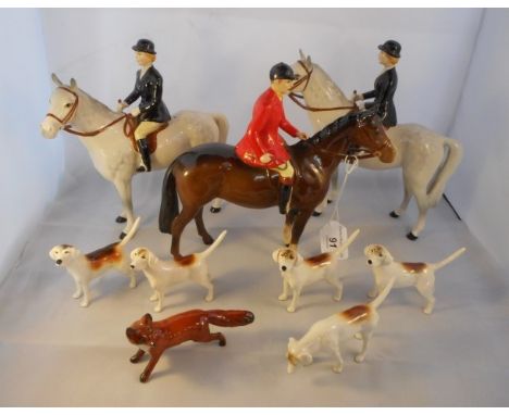 A Beswick hunting group, comprising two Huntswomen figures, numbered F1730, a Huntsman figure, numbered S1501, five hounds an