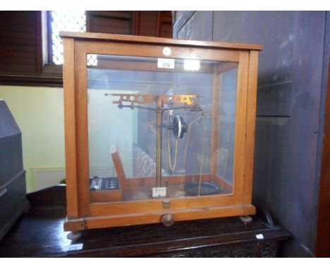 A cased set of balance scales, makers name label reads River Chemical Company Limited, Nottingham.