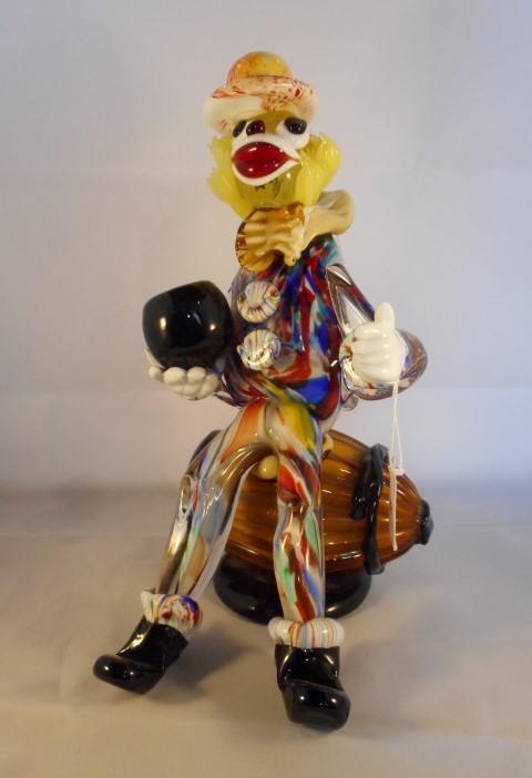 A 1960's murano glass clown, seated on a barrel, 28cm. 1960s murano glass clowns