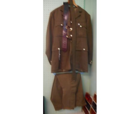 A WWII Army uniform, comprising jacket and trousers, brown leather belt and an associated pair of jodhpurs .