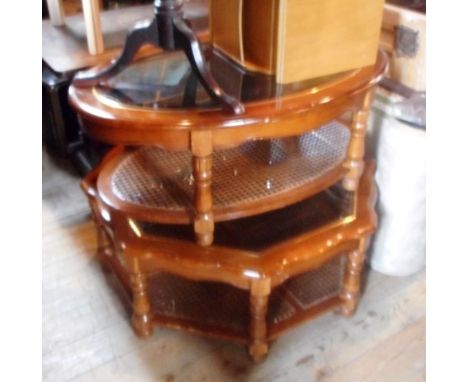 Two modern two tier coffee tables, each having glass top and cane lower shelf, one hexagonal and the other oval, together wit