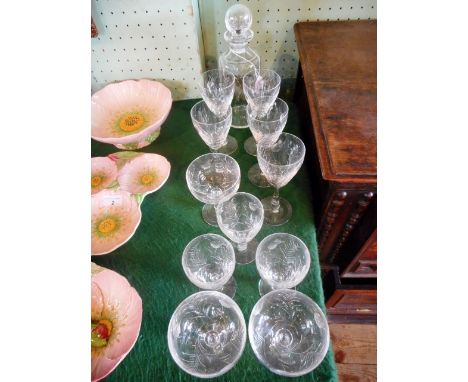 A cylindrical Edinburgh crystal decanter and stopper, together with eleven stemmed drinking glasses.