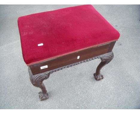 Quality rectangular mahogany piano stool with lift-up upholstered top, on ball and claw feet 