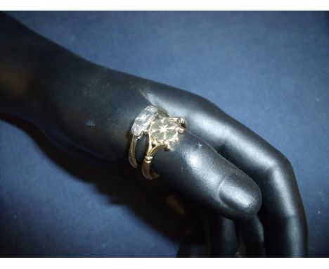 9ct gold four leaf clover pattern ring set with a central diamond chip and a 18ct gold &amp; platinum three stone diamond chi