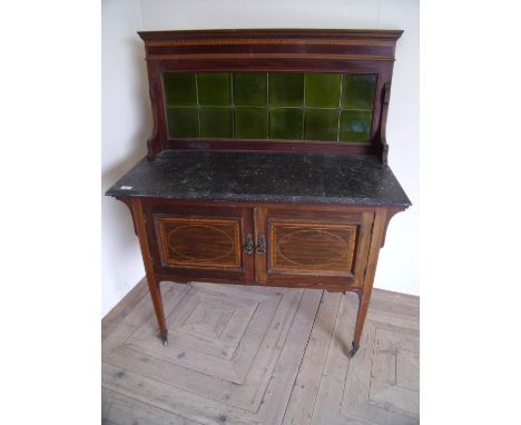 Edwardian mahogany inlaid washstand with raised tile back above marble top and two panelled cupboard doors, on square taperin