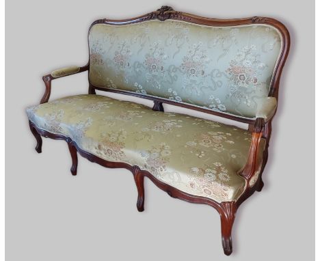 A French rosewood sofa, the shaped carved and upholstered back above a similar seat with carved scroll arms raised upon cabri