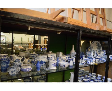 A large quantity of blue and white china to include egg cups, toast rack, mantel clock etc.