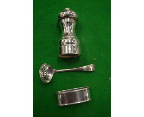 A silver pepper grinder and two other items.