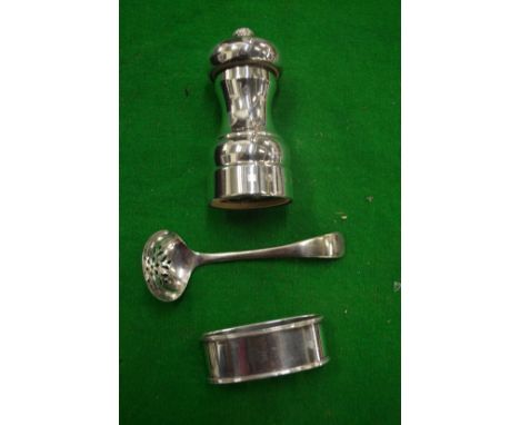 A silver pepper grinder and two other items.