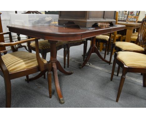 A mahogany twin pillar extending dining table.