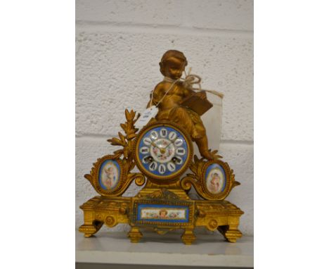 A French spelter mantel clock with porcelain panels.