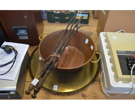 A brass tray, copper preserve pan and a set of three fireside tools.