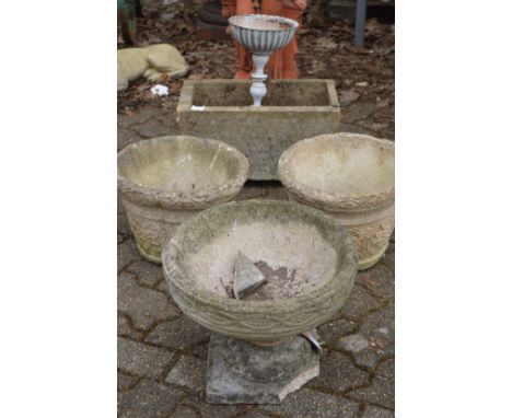 Four various composite garden planters and a small white painted planter.