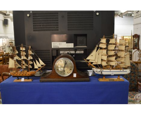 Two model ships and a mantel clock.